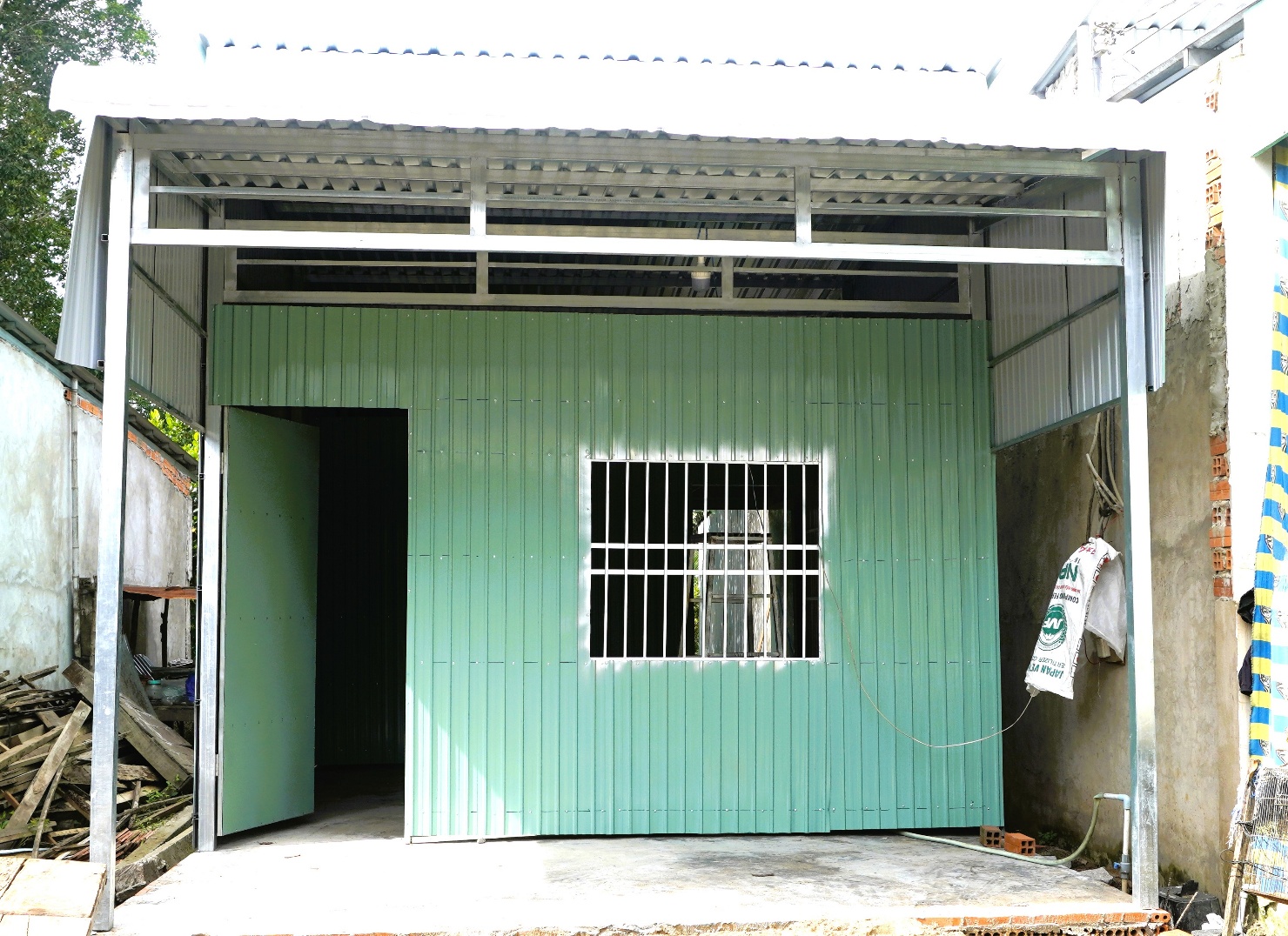 A green shed with a door openAI-generated content may be incorrect.