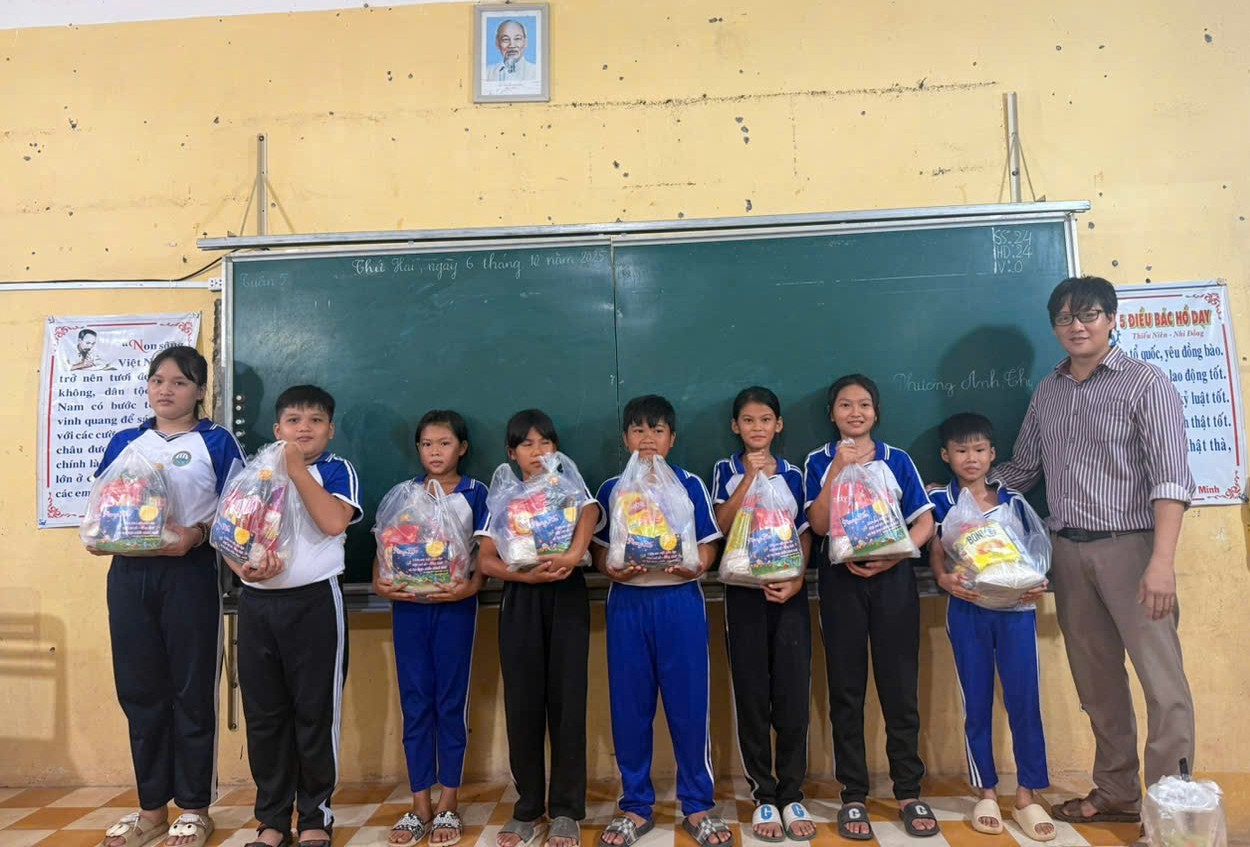 Description: A group of people standing in front of a chalkboardAI-generated content may be incorrect.